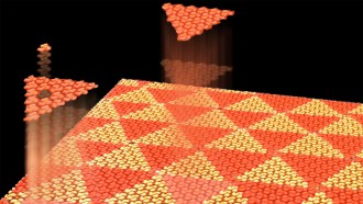 In this illustration, a flat plane is made up of orange and red triangles, with smaller molecules within the triangles rotated to create irregular patterns.